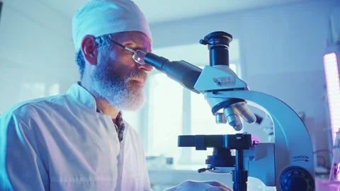 Chemist Analyzing Samples in Neon-Lit Laboratory Researching Innovative Medicine Stock Footage 283523925