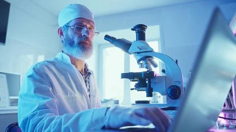 Chemist Analyzing Samples in a Neon-Lit Laboratory During Innovative Research Stock Photos