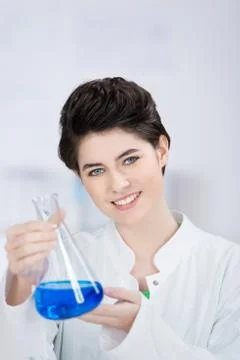 Chemist with a blue solution in a flask Stock Photos