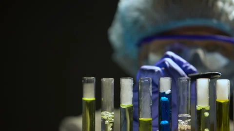 Chemist checking reaction in test tubes ... | Stock Video | Pond5