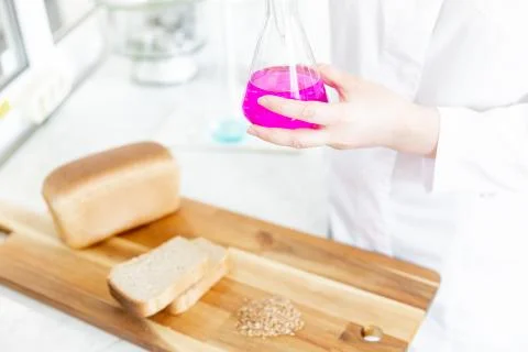 Chemist conducts analysis and test of grain in laboratory for manufacture and Stock Photos