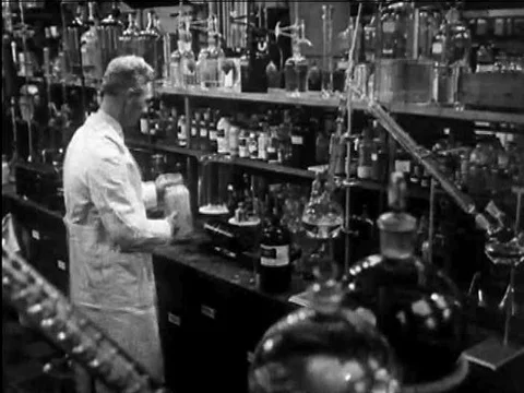 A chemist conducts an experiment hoping to create plastic from a soybean mixture Stock Footage 74964629