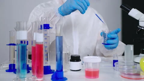 Chemist is examining reagents in laboratory, experiments and looking for Stock Footage 158386754