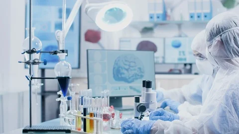 Chemist giving a test sample to her colleague Stock Footage 109399098