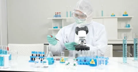 Chemist group working with a microscope in laboratory Stock Footage 133095044