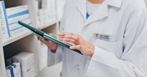 Chemist, hands and scroll in pharmacy with tablet, telehealth website or review Stock Photos