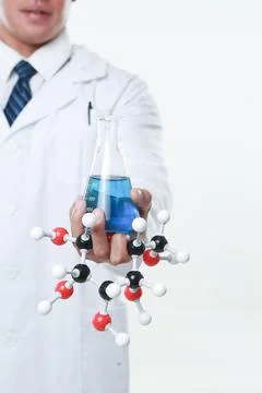 A chemist holding a flask Stock Photos