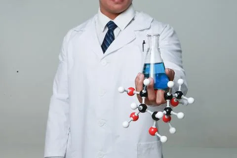 A chemist holding a flask Stock Photos