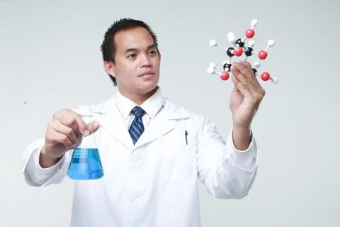 A chemist holding a flask Stock Photos