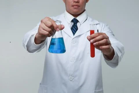 A chemist holding a flask Stock Photos