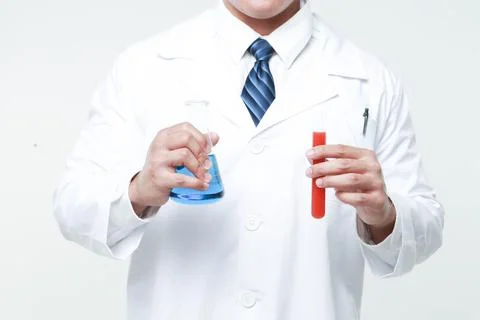 A chemist holding a flask Stock Photos