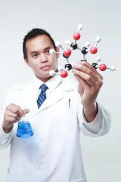 A chemist holding a flask Stock Photos