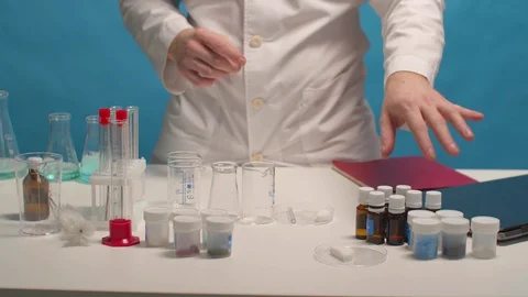 Chemist looking for reagent on the table Stock Footage 129972911
