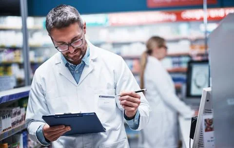 Chemist, man and reading in pharmacy with clipboard, quality assurance or i.. Stock Photos