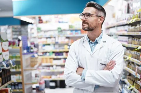 Chemist, man and thinking in pharmacy with arms crossed, contemplation and .. Stock Photos