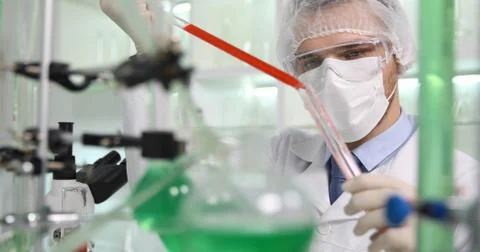 Chemist Man Use Micro Pipette to Transfer Liquid into Bottle Glass in Laboratory Stock Photos
