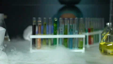 Chemist opening refrigerator and taking green transparent liquid sample, lotion Stock Footage 104995425