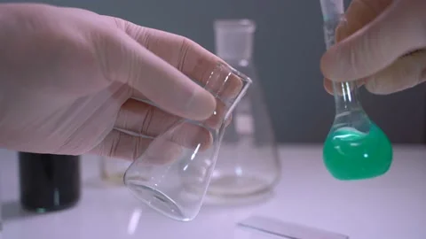 Chemist or scientist pouring liquid in lab flask. Concept research. First-person 스톡 동영상 131269992