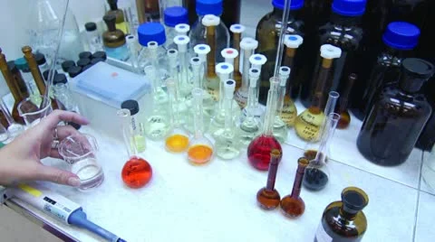 Chemist Pouring Orange Liquid into Flask in Laboratory Stock-Footage 11139034