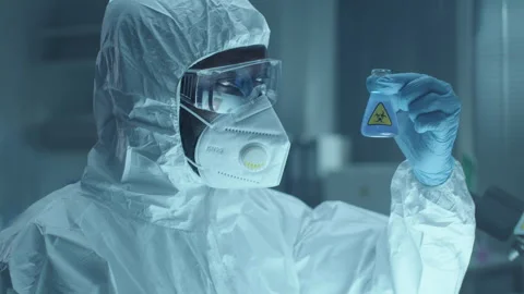 Chemist in Protective Uniform Examining Liquid in Flask during Lab Research Stock Footage 275494286