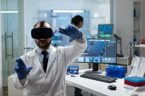 Chemist researcher analyzing sickness development using virtual reality headset Stock Photos