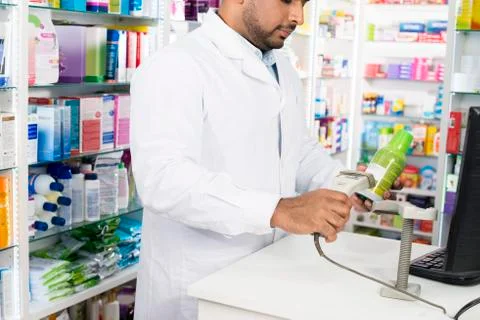 Chemist Scanning Barcode Of Product At Checkout Counter 写真素材