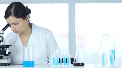 Chemist, Scientific Reseacher Working on Microscope in Laboratory Stock Footage 81054869