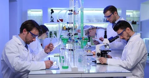 Chemist Team Scientists Conversation and Work Vials Glass Bottles in Laboratory Stock Footage 87934666