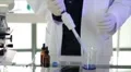 Chemist using a pipette to collect a sample HD Footage