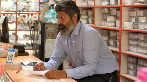 The chemist is verifying the list of medication names as written on the docto... Stock Footage 260799887