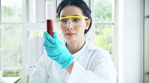 Chemist working in a lab, examine liquid chemical in test tube. Close up shot. Stock Footage 99013767