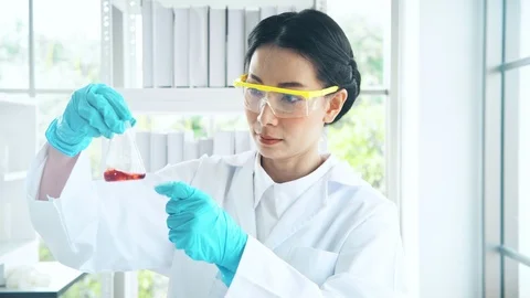 Chemist working in a lab, putting liquid chemical in test tube. Close up shot. Stock Footage 99013752