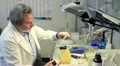 chemist working in a laboratory wiht automatic pipette and vortex HD Footage
