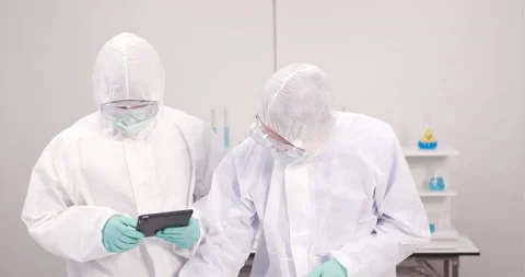 Chemist working with a microscope in laboratory, developing a vaccine Stock Footage 133092725