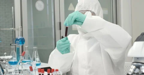 Chemist working with a microscope in laboratory, developing a vaccine Stock Footage 133095001