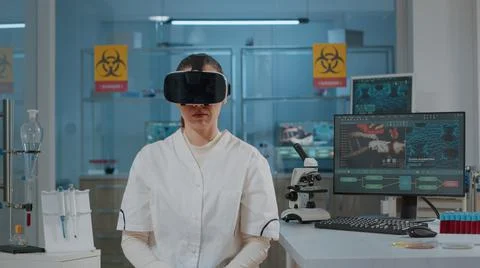 Chemist working with virtual reality headset in laboratory Stock Photos