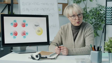 Chemistry teacher taking part in science webinar showing pictures on computer Stock Footage 204091925