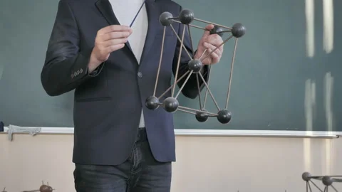 Chemistry Teacher Using Molecular Model While Teaching A Students Stock Footage 138047036