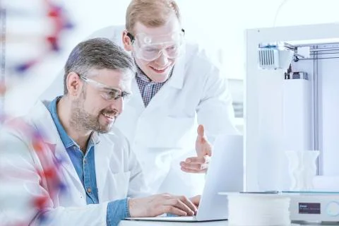 Chemists with laptop and printer Stock Photos