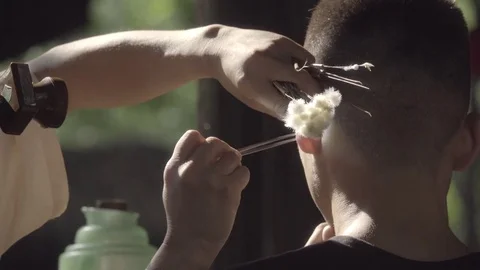 Chengdu man gets his ears cleaned Stock Footage 83732452