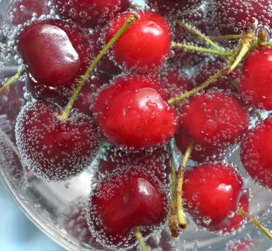 Cherries and Bubbles in water Stock Photos