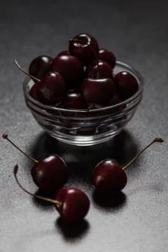 Cherries on black table Stock Photos