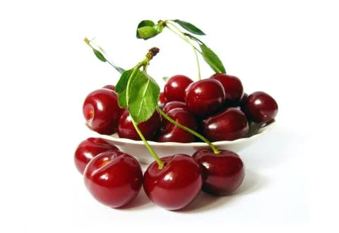 Cherries in a bowl on white background Stock Photos