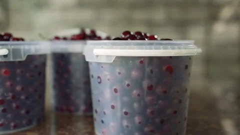 Cherries in buckets on the table Stock Footage
