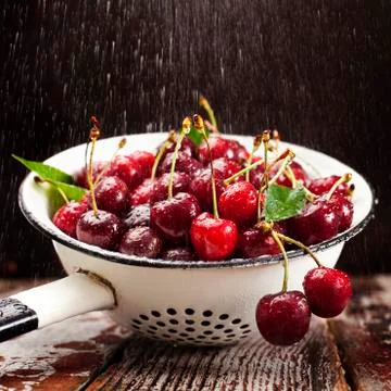 Cherries in colander Stock Photos