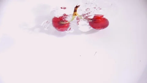 Cherries drop in water in slow motion causing the water to splash Stock Footage 91205964