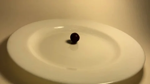 Cherries fall on a white plate. slow mo Stock Footage 111180553