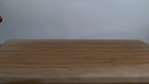 Cherries falling on chopping board in slow motion Stock Footage 100006402