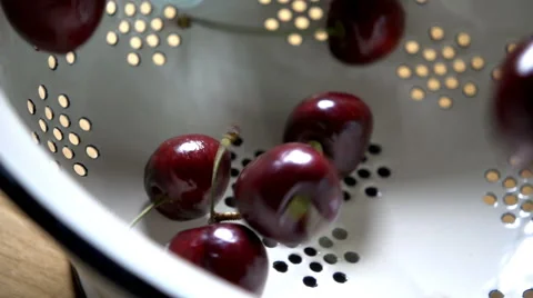 Cherries falling into colander in slow motion Stock Footage 61705934