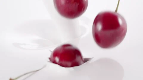 Cherries falling into the flow of milk Stock Footage 171888456